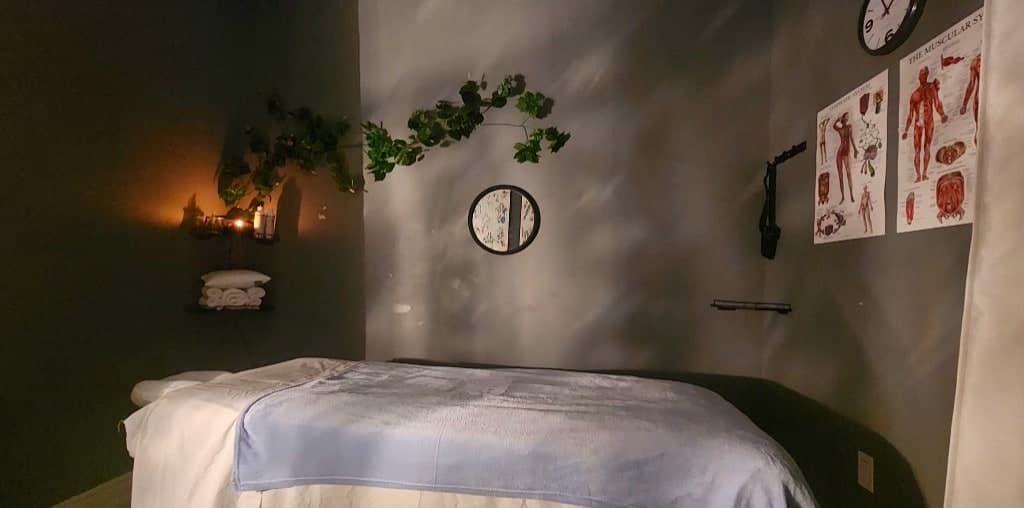Massage therapy treatment room with calming ambient lighting at Alleiry RMT AND WELLNESS